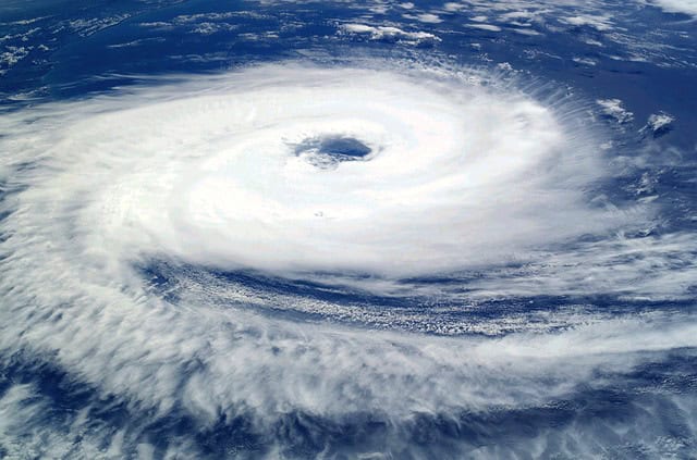 Satellite image of a powerful hurricane with a clear eye and swirling clouds.