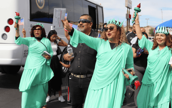 Latino community members celebrating with festive attire and American flags.