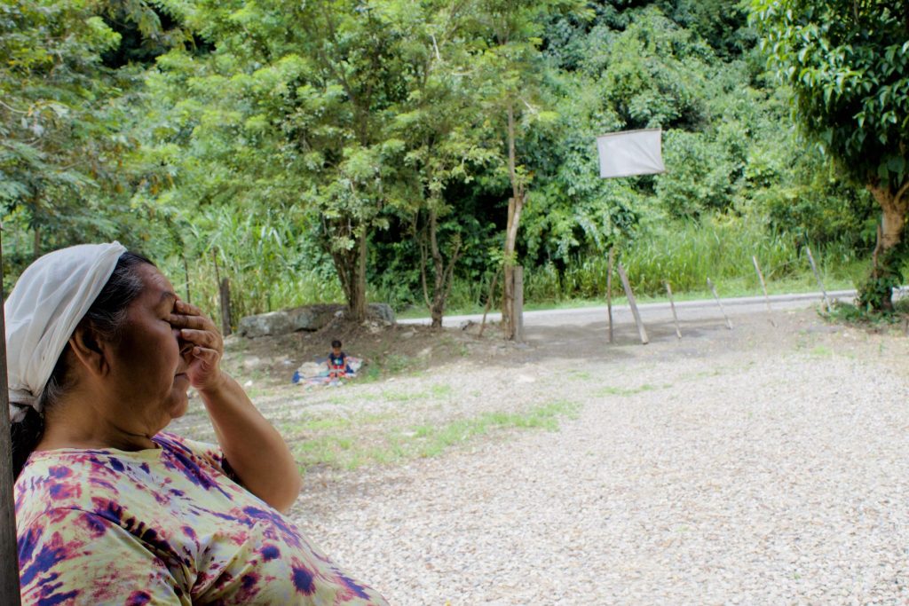 Venezuelan migrant woman crying outdoors amid diminishing aid and election uncertainty.