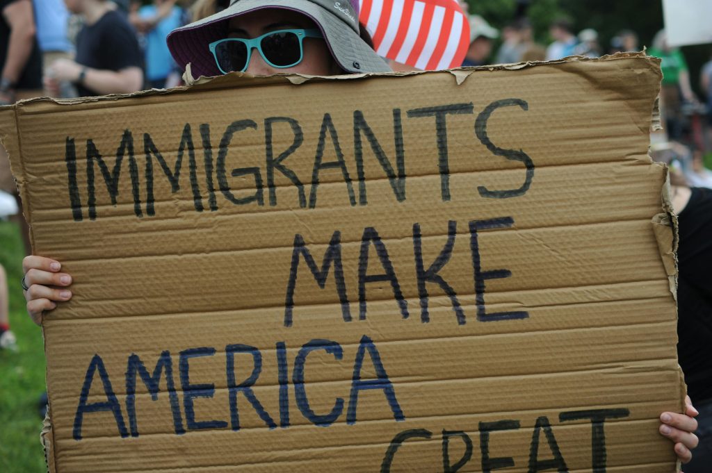 Close-up of sign reading 'Immigrants Make America Great' at a Baltimore rally.
