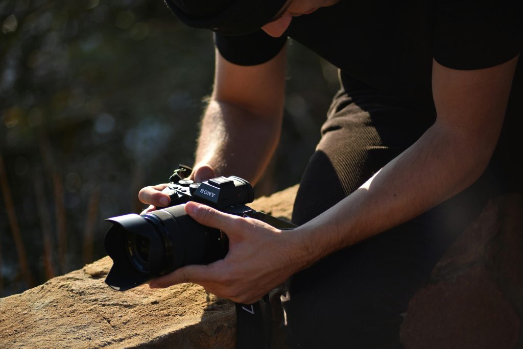 A photographer in South Africa capturing nature with a Sony camera outdoors.