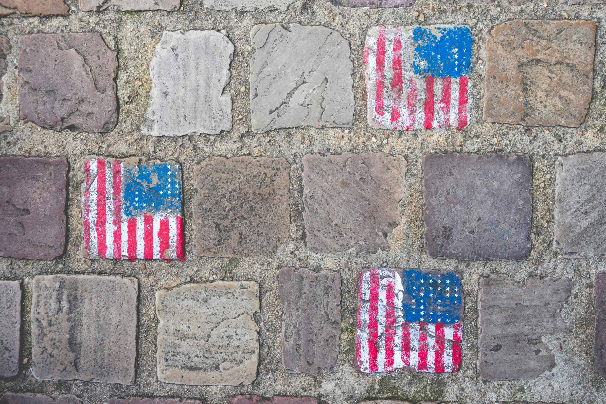 American flag graffiti on old stone wall in Carentan les Marais, Normandy, France.