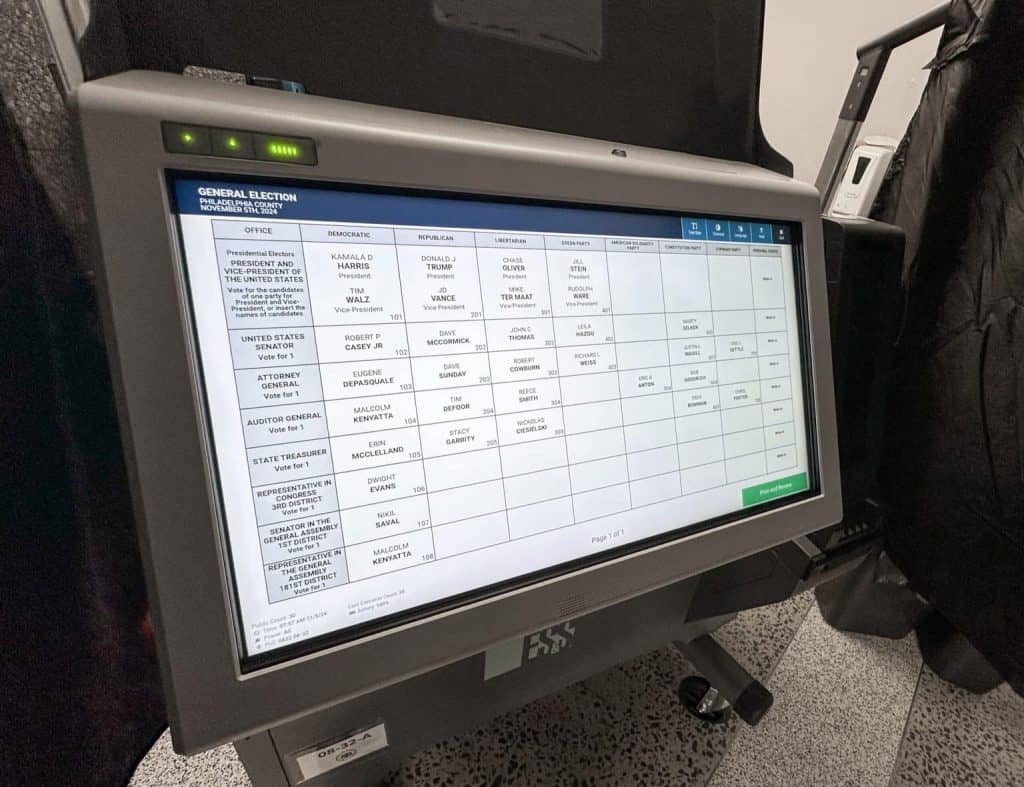 Ballot counting machine displaying election results at a polling station.