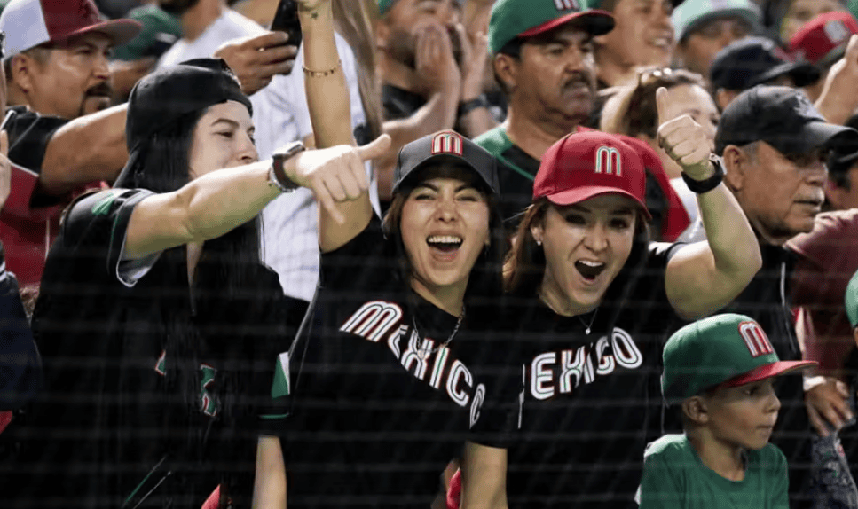 Fans celebrating at a baseball game at Chase Field during a Latino News Network event.